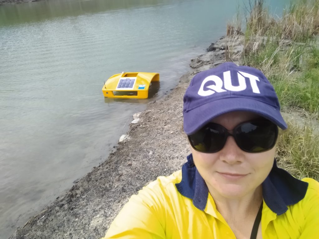 QUT Associate Professor Sara Couperthwait and the robotic boat.